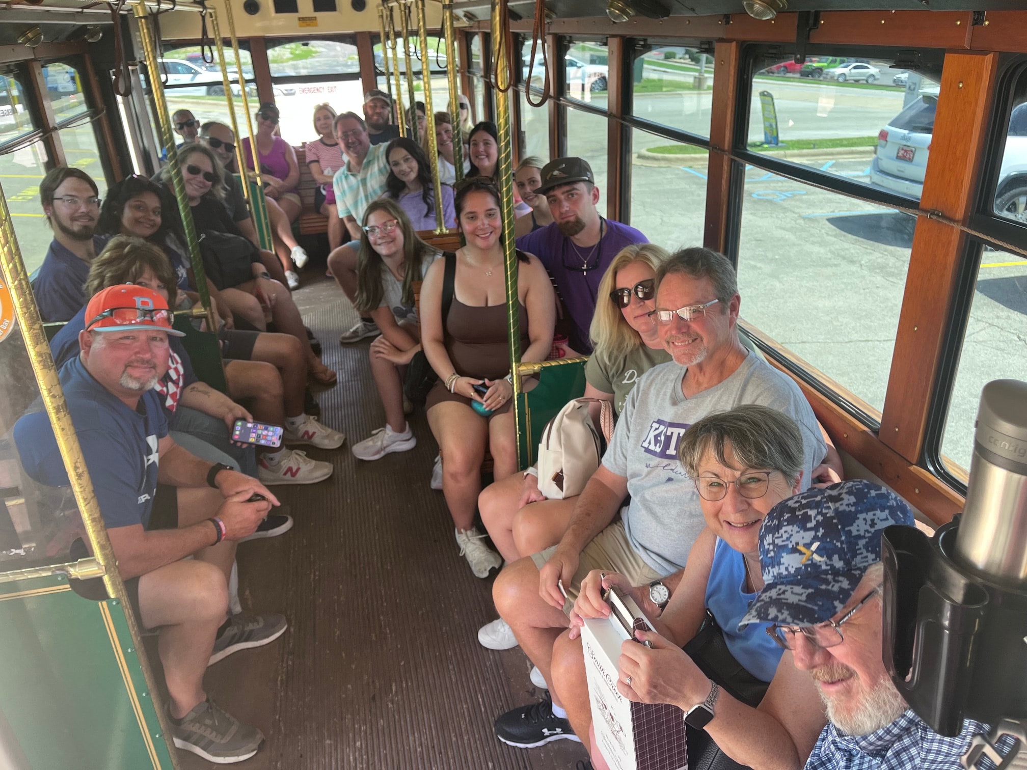 Happy guests seated inside the MayHam trolley bus on tour