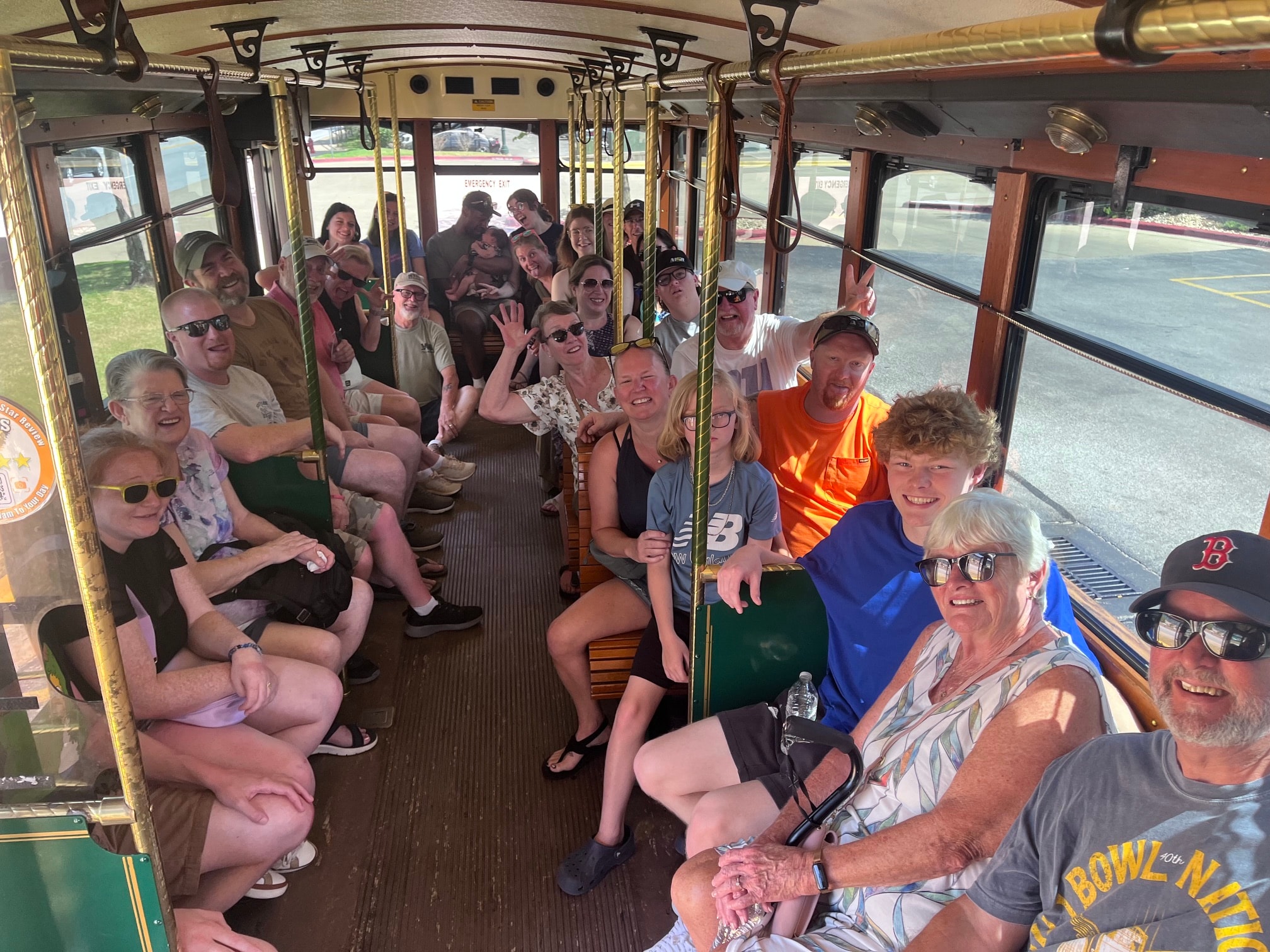 Guests laughing and waving inside the MayHam trolley bus