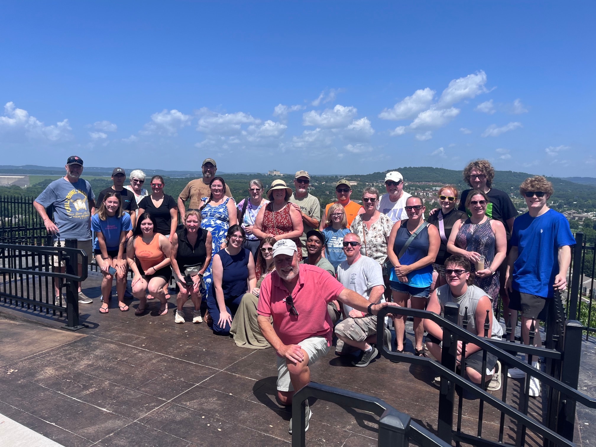 Tour group posing at Branson's scenic Ozark Mountain overlook